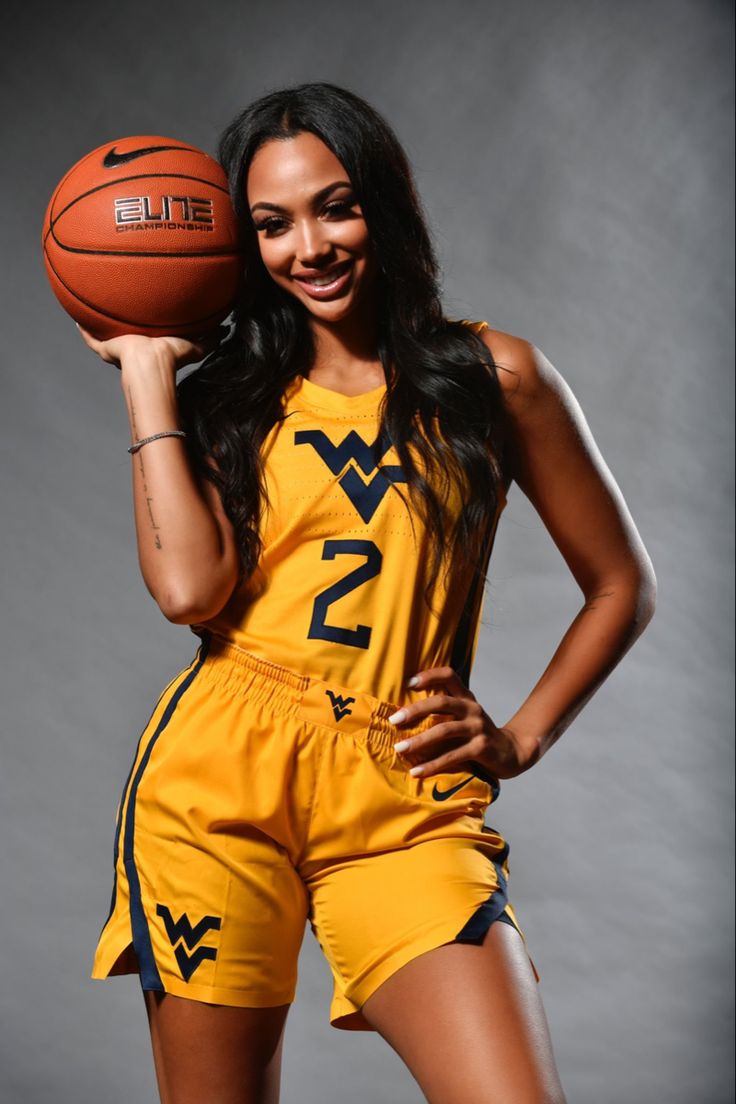 a woman holding a basketball in her right hand