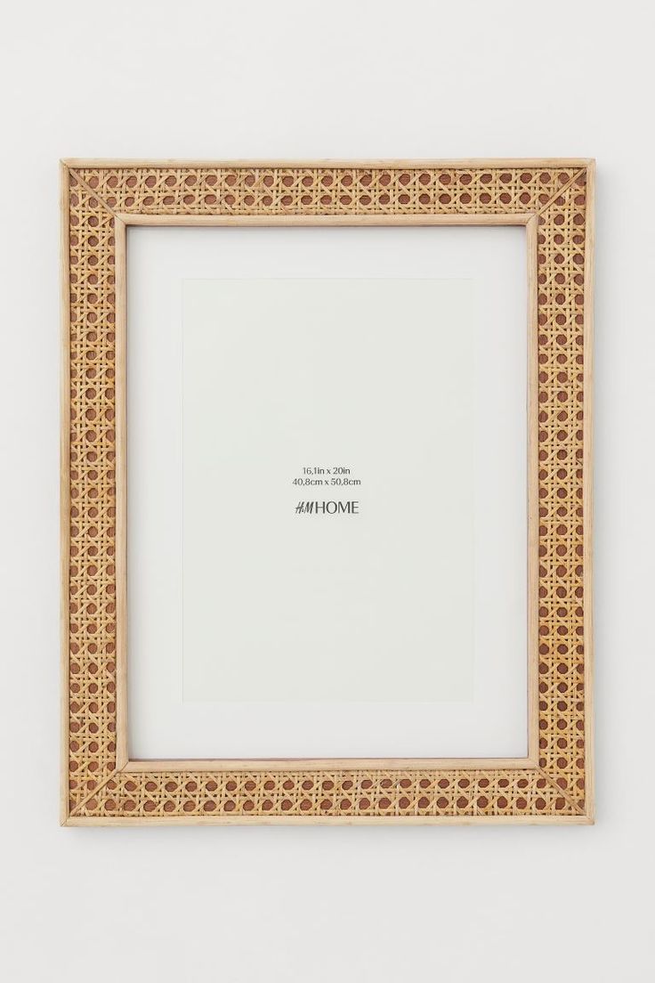 an empty wooden frame on the wall with a quote written in white and gold lettering