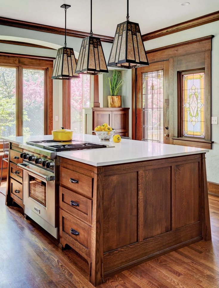 a large kitchen with wooden cabinets and an island in front of the stove top oven