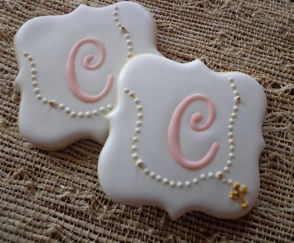 two decorated cookies sitting on top of a table