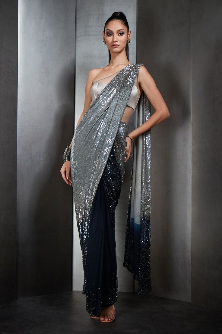 Silver and sapphire saree gown with all-over sequin embellishments. Component: 1 Pattern: Embellished Type Of Work: Sequins Neckline: One Shoulder Sleeve Type: Sleeveless Fabric: Tulle Color: Silver, Blue Other Details:  Draped saree gown Sheer panels Occasion: Cocktail - Aza Fashions Draped Saree Gown, Ombre Saree, Saree Gowns, Rahul Khanna, Draped Saree, Sequin Saree, Gown For Women, Saree Gown, Drape Saree