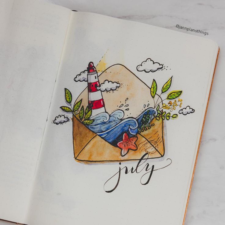 an open book with the words july written on it and a drawing of a lighthouse