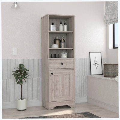 a white bathroom with a wooden cabinet next to a potted plant on the floor