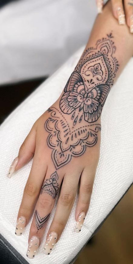 a woman's hand with a tattoo on it