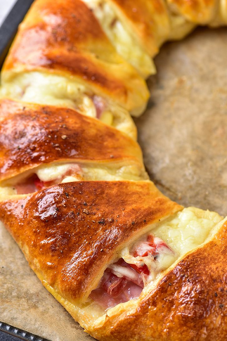 a pastry with ham and cheese on it