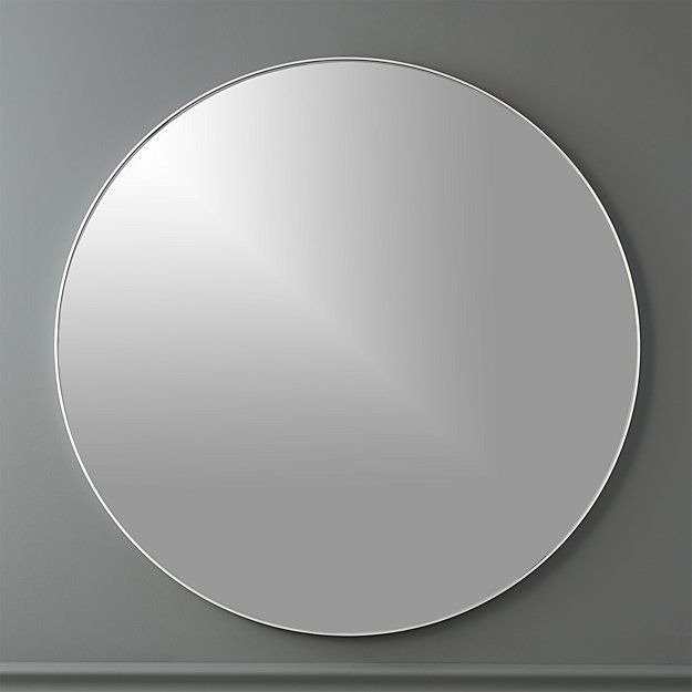 a round mirror mounted to the side of a wall