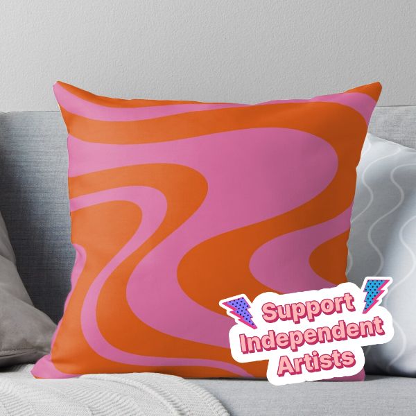 an orange and pink pillow with the words support independent artists on it