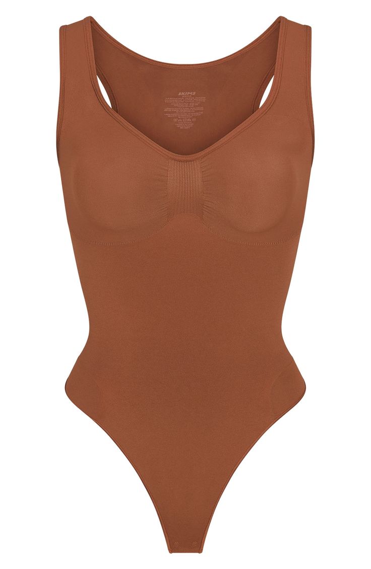 From Kim Kardashian's SKIMS, this curve-hugging bodysuit with a thong back gives support and disappears under clothes. Snap closure Scoop neck Sleeveless 41% recycled nylon, 41% nylon, 18% elastane Machine wash, tumble dry Imported High Cut Nylon Bodysuit With Built-in Bra, Solid Nylon Bodysuit With Built-in Bra, Nylon Bodysuit With Built-in Bra And Scoop Neck, Stretch Nylon Bodysuit With Built-in Bra, Nylon Smoothing Scoop Neck Bodysuit, Scoop Neck Smoothing Nylon Bodysuit, Smoothing Nylon Scoop Neck Bodysuit, Smoothing Nylon Bodysuit With Scoop Neck, Sleeveless Stretch Nylon Shapewear