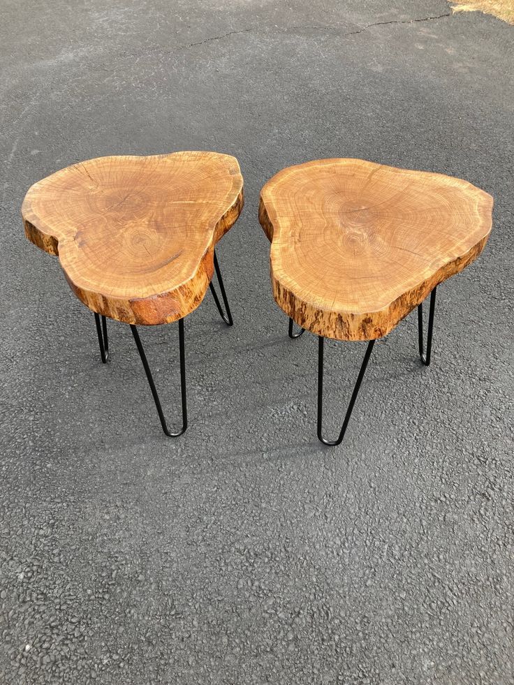 two wooden tables sitting on top of each other in the middle of a parking lot