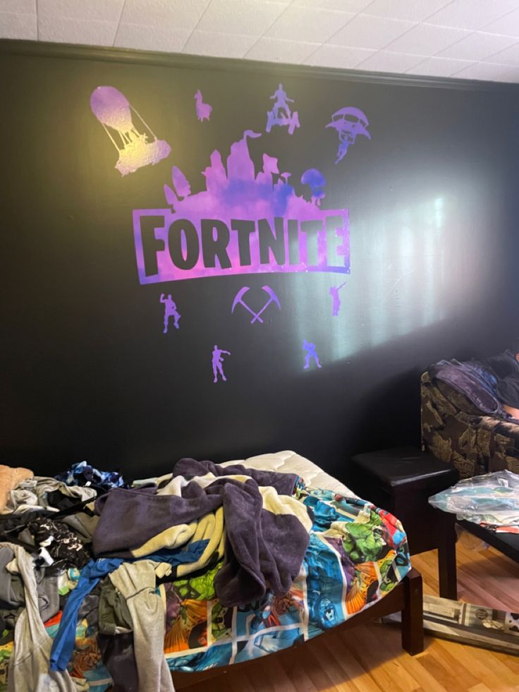 a bed room with a neatly made bed and graffiti on the wall above it that says fortnite