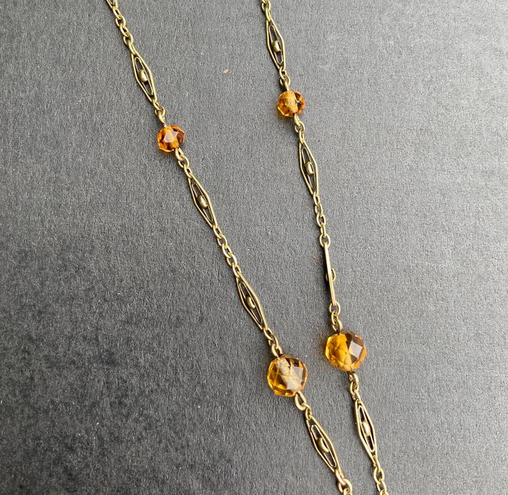 "A lovely Art Deco era 14K gold and citrine drop necklace. The citrine briolette drop is a sunny yellow color and measures an impressive 34 mm long by 17 mm wide by 11.4 mm deep. The many facets around the entire stone allows it to really shine. It has some natural inclusions as well as some minor surface abrasions as shown in the photos. The citrine is suspended from a delicate filigree necklace with citrine bead stations. Lovely open gold work on each gold panel. The clasp is stamped \"14K\" f Stacked Diamond Bands, Filigree Necklaces, Citrine Beads, Sunny Yellow, Snake Ring, Gold Work, Disc Pendant, Art Deco Diamond, Art Deco Era