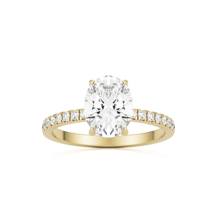 a yellow gold engagement ring with an oval cut diamond in the center and side stones