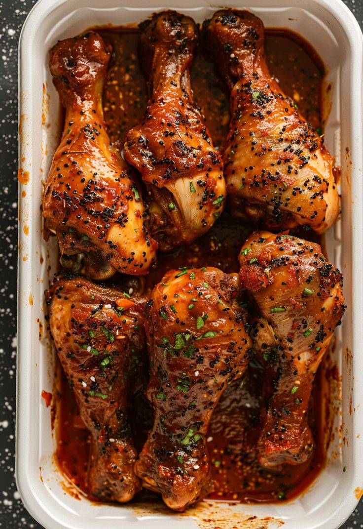 chicken legs covered in marinara sauce and garnished with parsley