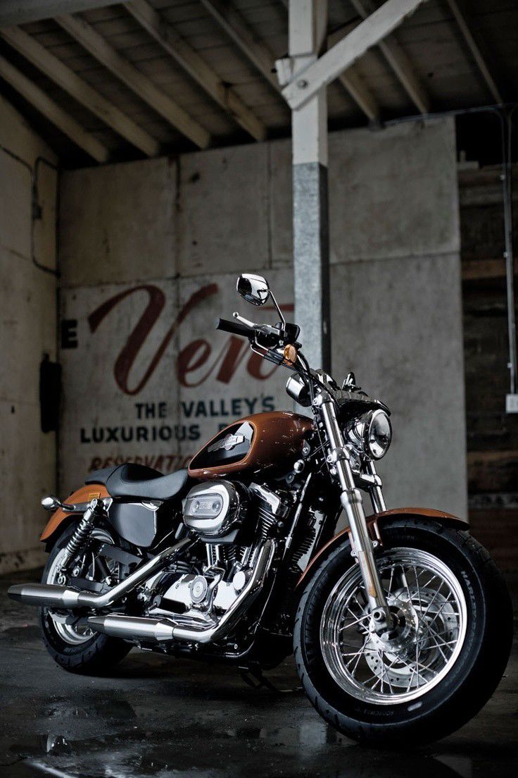 a motorcycle is parked in front of a sign