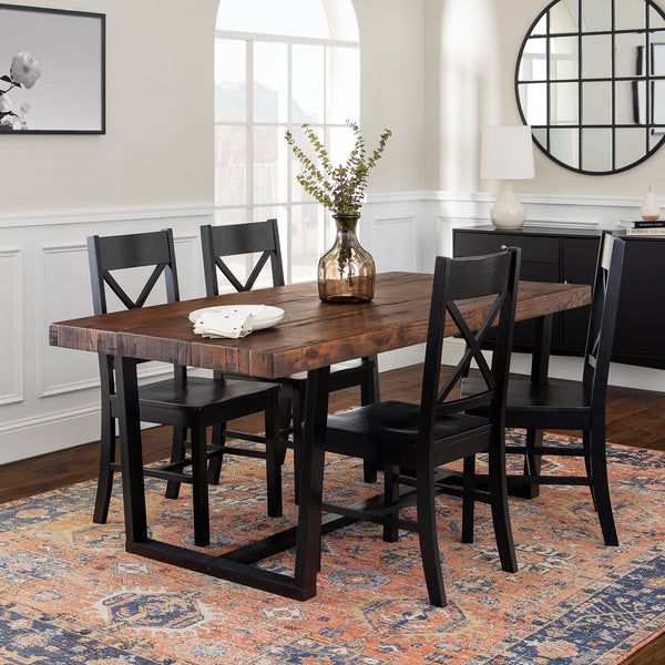 a dining room table with four chairs and a vase on the rug in front of it