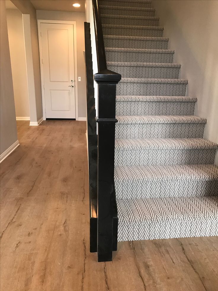 an empty hallway with stairs leading up to the door