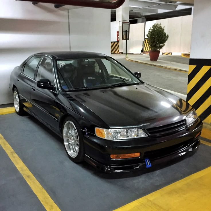 a black car parked in a parking garage