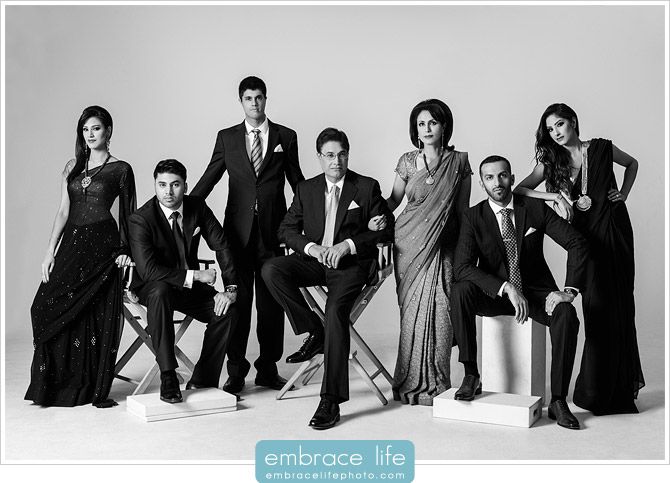 a black and white photo of people in formal wear posing for a group shot with the caption embrace life