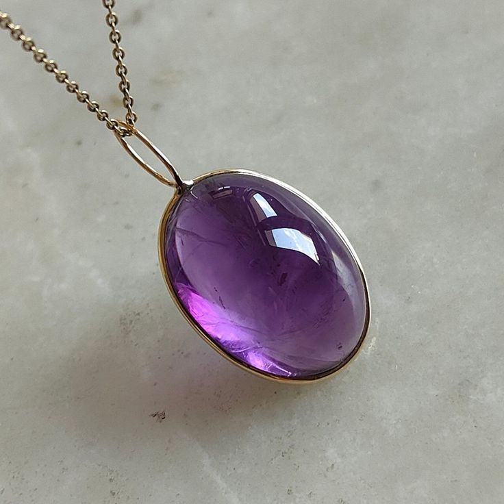 This stunning Pendant is set in 14k Solid Yellow Gold with Natural Purple Amethyst with utmost precision. It is a unique gemstone Pendant for nearly every occasion and is completely hassle-free jewelry. ITEM DETAILS: * Gem: Purple Amethyst * Gem Size: 15x20mm * Gem Shape: Oval Fix Loop * Gem Weight: 18.60 carats * Gold Purity: 14KT  * Gold Weight: 0.41 gram * Total Weight of the Pendant: 4.13 gram The Gold purity is guaranteed and it comes with authentic 14KT gold hallmark. Since my items are ha Elegant Amethyst Cabochon Gemstones, Elegant Cabochon Amethyst Gemstones, Timeless Amethyst Jewelry Gift, Formal Amethyst Jewelry With Polished Finish, Yellow Gold Amethyst Briolette Jewelry, Yellow Gold Briolette Amethyst Jewelry, Classic Amethyst Birthstone, Formal Amethyst Oval Cabochon Jewelry, Formal Amethyst Jewelry, Oval Cabochon