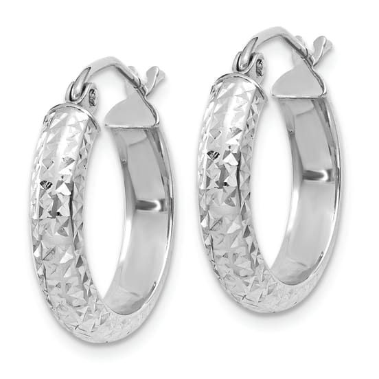 Rhodium over 14k white gold diamond-cut hoop earrings. Measure approximately 11/16"L x 1/8"W and have saddleback backings. White Diamond Cut Hoop Jewelry, Silver Diamond Cut Huggie Jewelry, White Gold Huggie Jewelry With Diamond Cut, Silver Huggie Jewelry With Diamond Cut, White Diamond Cut Small Hoop Earrings, Sterling Silver Hoop Earrings With Diamond Cut For Anniversary, Oval Sterling Silver Hoop Earrings With Diamond Cut, Oval Diamond Cut Sterling Silver Hoop Earrings, Small Hoop Sterling Silver Jewelry With Diamond Cut