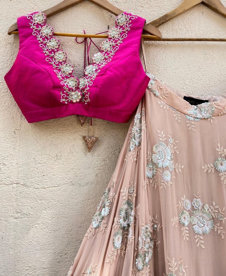 This exquisite Rani Pink and Tan Embroidered Lehenga Set with Ruffle Dupatta is a vision of elegance, combining the charm of traditional craftsmanship with modern style. Made from georgette fabric, the tan umbrella lehenga features intricate sequin and thread work floral motifs, beautifully accentuated by a wide, shimmering gota border in gold and vibrant pink, adding a regal touch to your look. Paired with a striking rani pink raw silk blouse, it dazzles with its plunging neckline adorned with Silk Choli With Mirror Work For Party, Silk Lehenga With Mirror Work For Party, Elegant Pink Choli With Mirror Work, Elegant Pink Dola Silk Choli, Pink Anarkali Set With Mirror Work For Party, Pink Party Wear Anarkali Set With Mirror Work, Pink Silk Choli For Parties, Pink Silk Choli For Party, Pink Silk Choli With Mirror Work