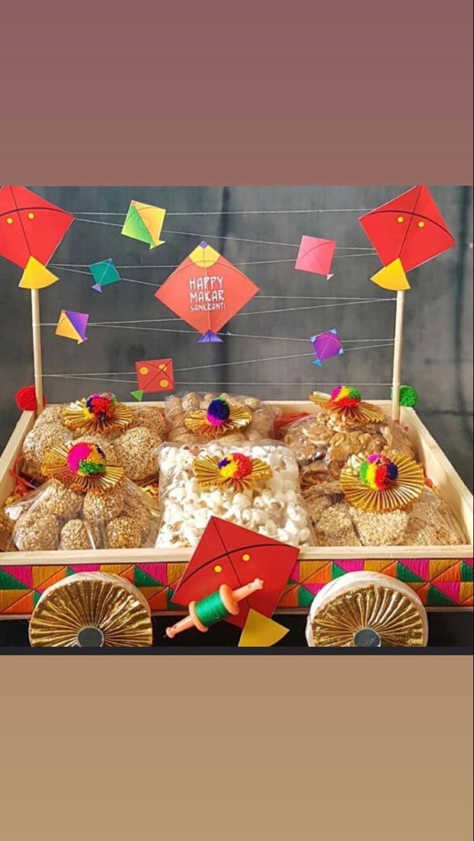 a wooden wagon filled with lots of food and paper kites on top of it