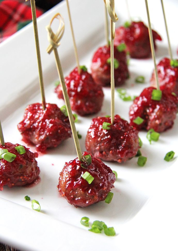 small appetizers with toothpicks on a white plate