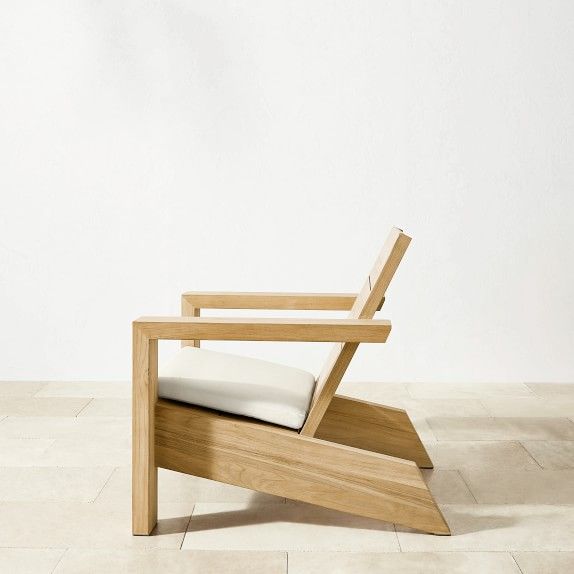 a wooden chair sitting on top of a tile floor