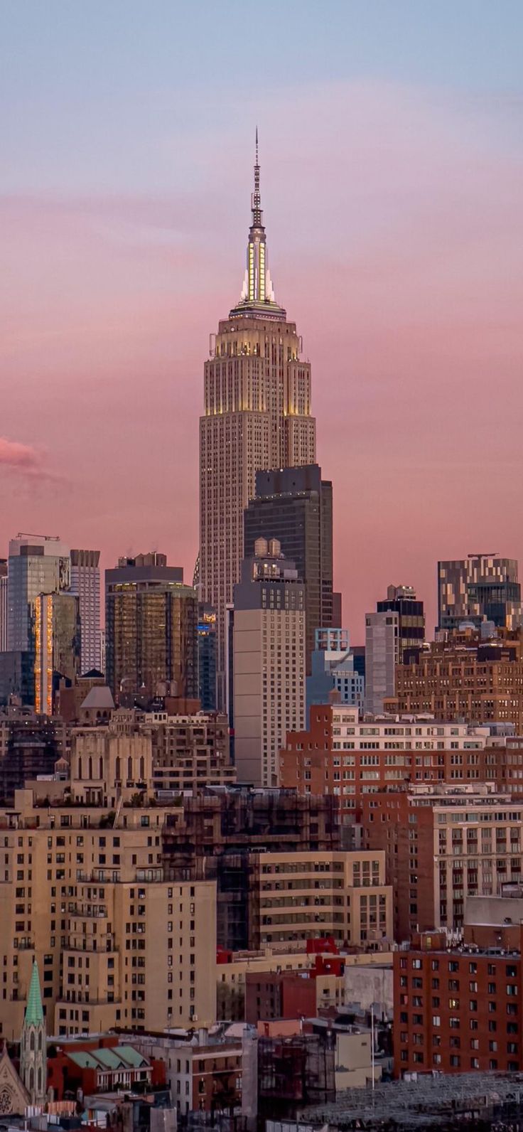 the empire state building towering over new york city