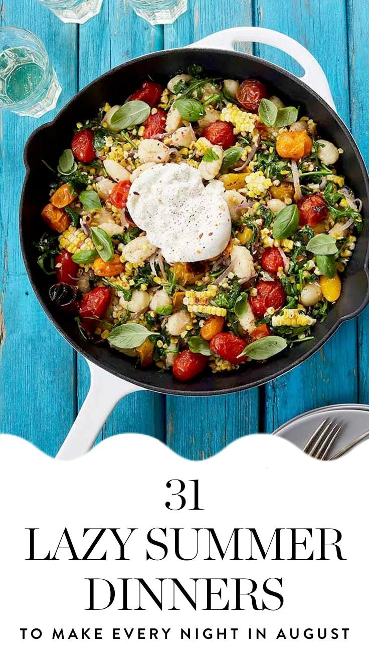 a skillet filled with vegetables and sauce on top of a blue wooden table