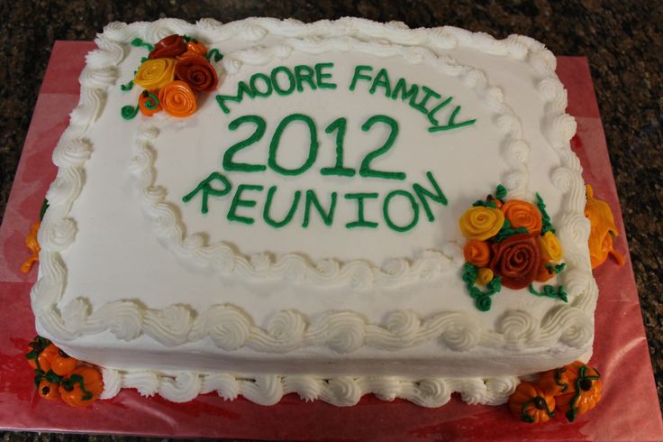 a white cake with orange and yellow flowers on it that says more family 2012 reunion