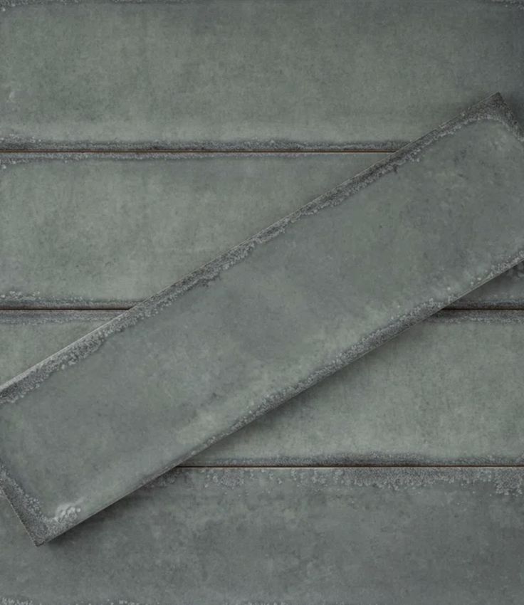 a gray towel laying on top of a wooden floor