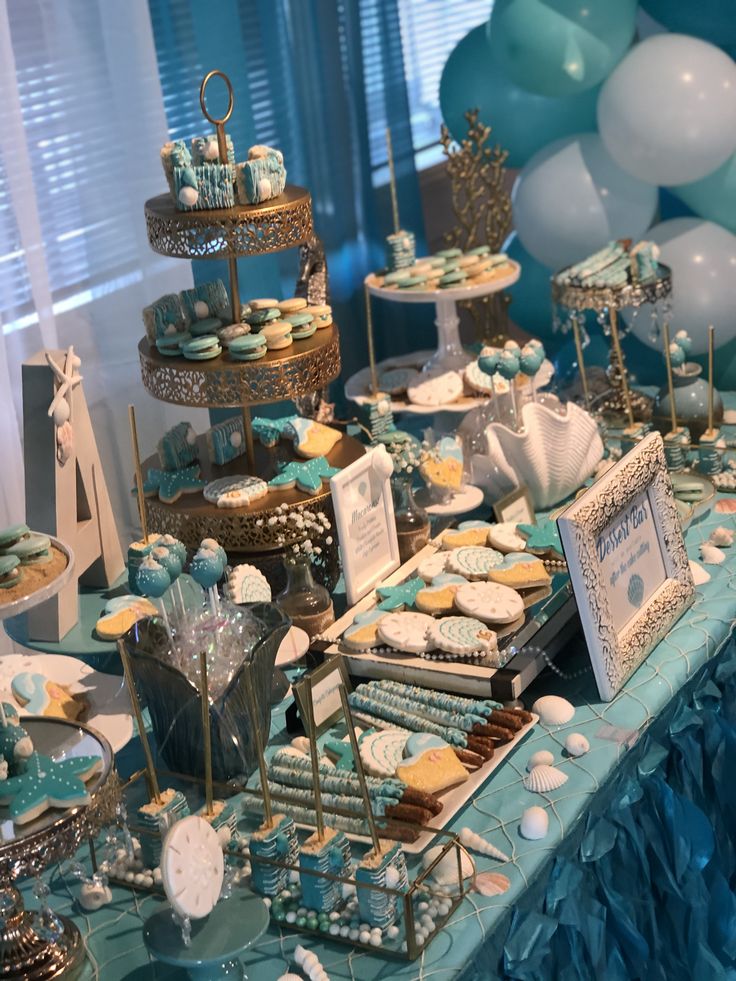 a dessert table with blue and white decorations