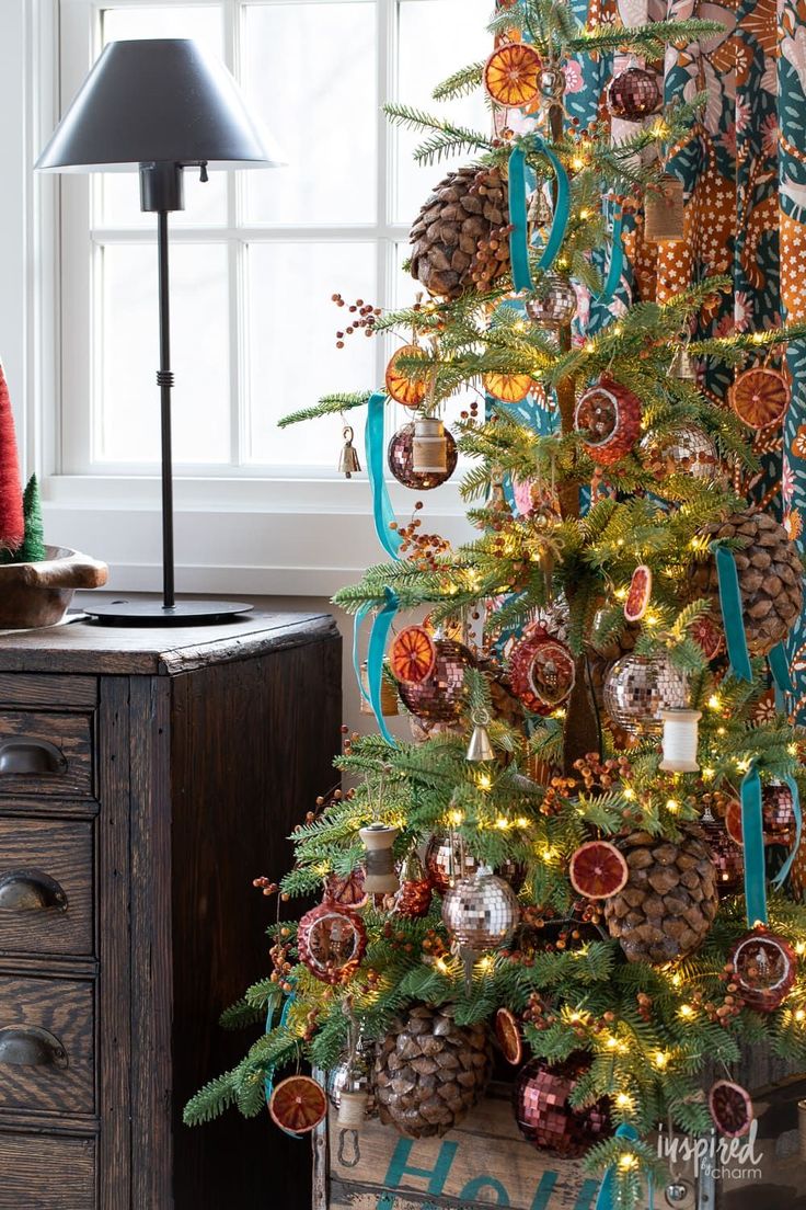 a decorated christmas tree with pine cones and ornaments