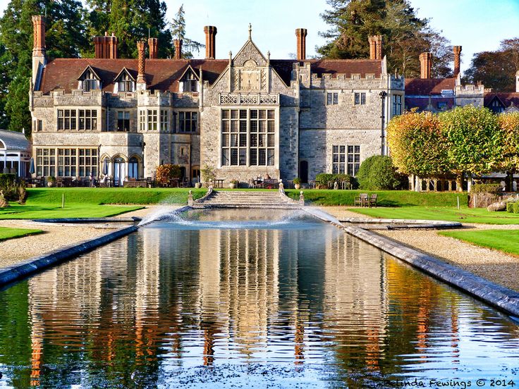 a large building with a pond in front of it