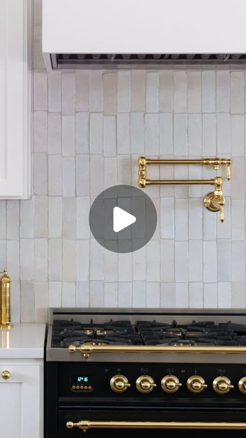 a black stove top oven sitting inside of a kitchen next to white cabinets and counter tops