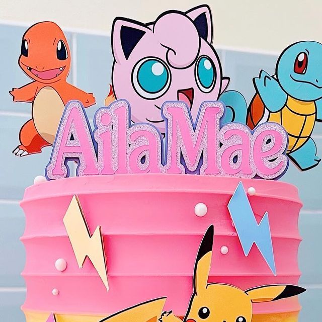 a pokemon themed birthday cake with the name ah mae on it and some pikachu