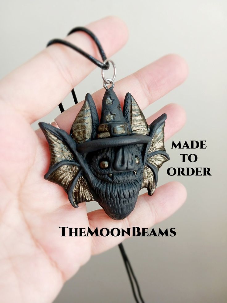 "THE WITCH BAT PENDANT NECKLACE MADE TO ORDER PROCESSING TIME 2-3 WEEKS It will be created for you, just like the one in the pictures, please allow slight variations due to the handmade nature of the piece, which makes each bat unique :) The new version of my classic Chubby Bat pendant This one was made using Black polymer clay With a witchy hat Hand-painted with metallic tones  It is 2\" wide and 2\" tall comes with a black cotton cord 18\" with a 2\" extension chain It comes in a gift box CARE Halloween Cosplay Novelty Jewelry, Halloween Novelty Jewelry For Cosplay, Handmade Magical Jewelry For Halloween, Black Fantasy Jewelry For Costume, Black Fantasy Costume Jewelry, Fantasy Black Costume Jewelry, Handmade Adjustable Witchy Necklaces, Handmade Whimsical Jewelry For Cosplay, Whimsical Handmade Jewelry For Cosplay