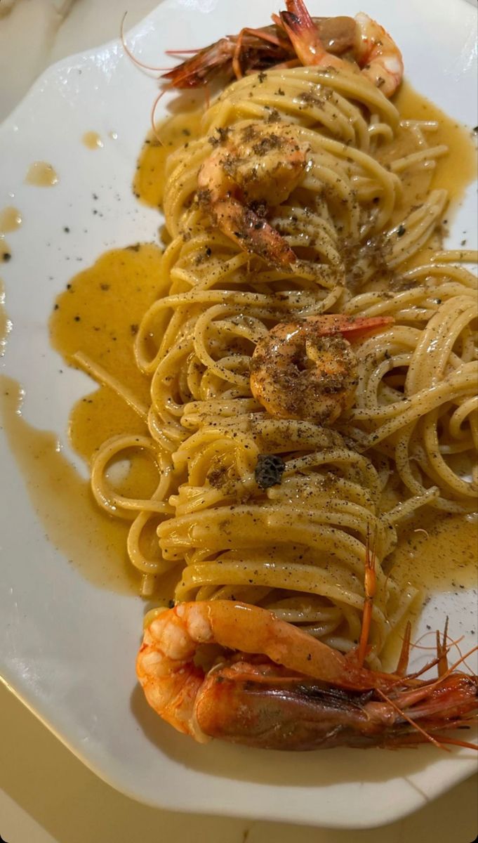 pasta with shrimp and sauce on a white plate