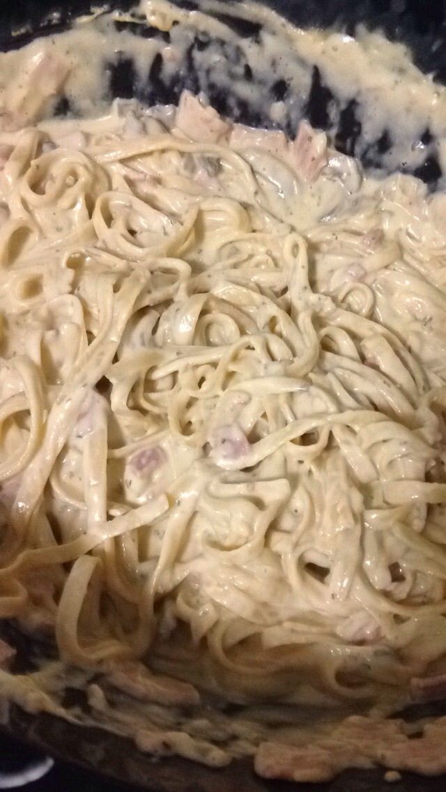 a bowl filled with pasta and sauce on top of a stove