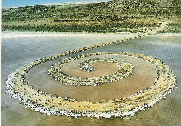 a painting of a spiral in the middle of water with rocks and grass on it