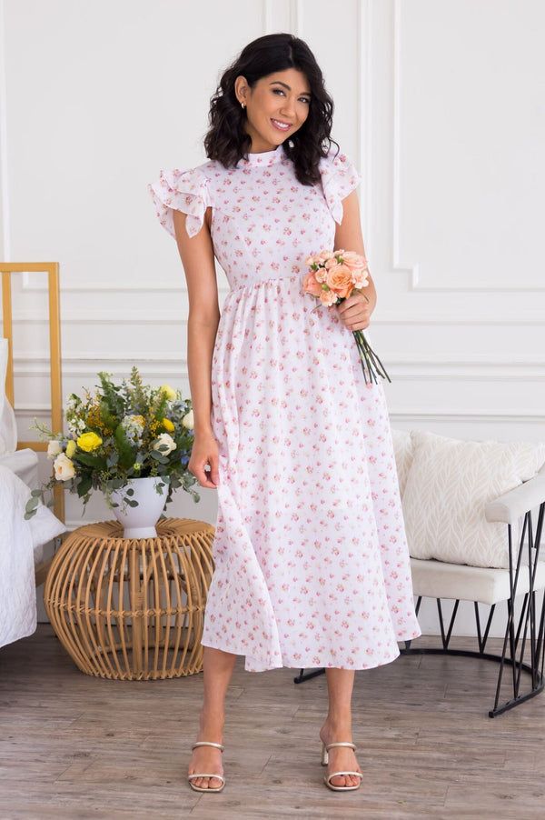 The Candyce Pink Ruffle Sleeve Dress With Floral Print, Pink Floral Print Dress With Ruffle Sleeves, Pink Cap Sleeve Summer Dress, Pink Cap Sleeve Dress For Summer, Modest Ruffle Sleeve Spring Dresses, Modest Short Sleeve Floral Dress For Spring, Feminine Pink Midi Dress With Ditsy Floral Print, Feminine Dresses With Ruffles And Cap Sleeves, Feminine Ruffled Cap Sleeve Dresses