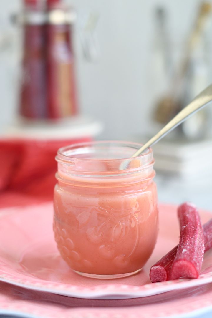 a pink plate topped with a jar filled with liquid