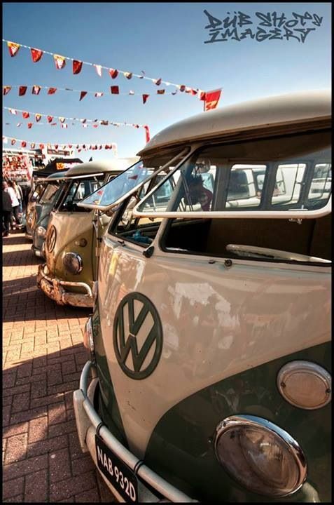 an old vw bus parked next to other cars