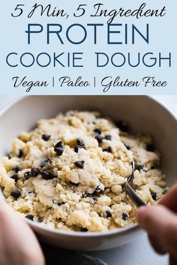 a white bowl filled with cookies and chocolate chips