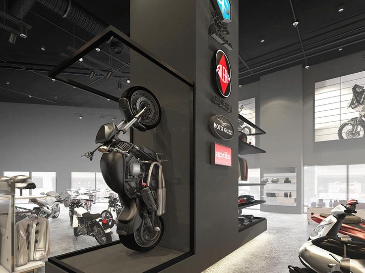 a motorcycle is on display in a showroom with several other motorcycles and scooters