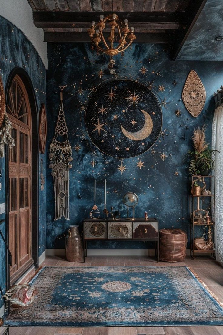 a room with blue walls and wooden floors, decorated in gold stars and moon designs