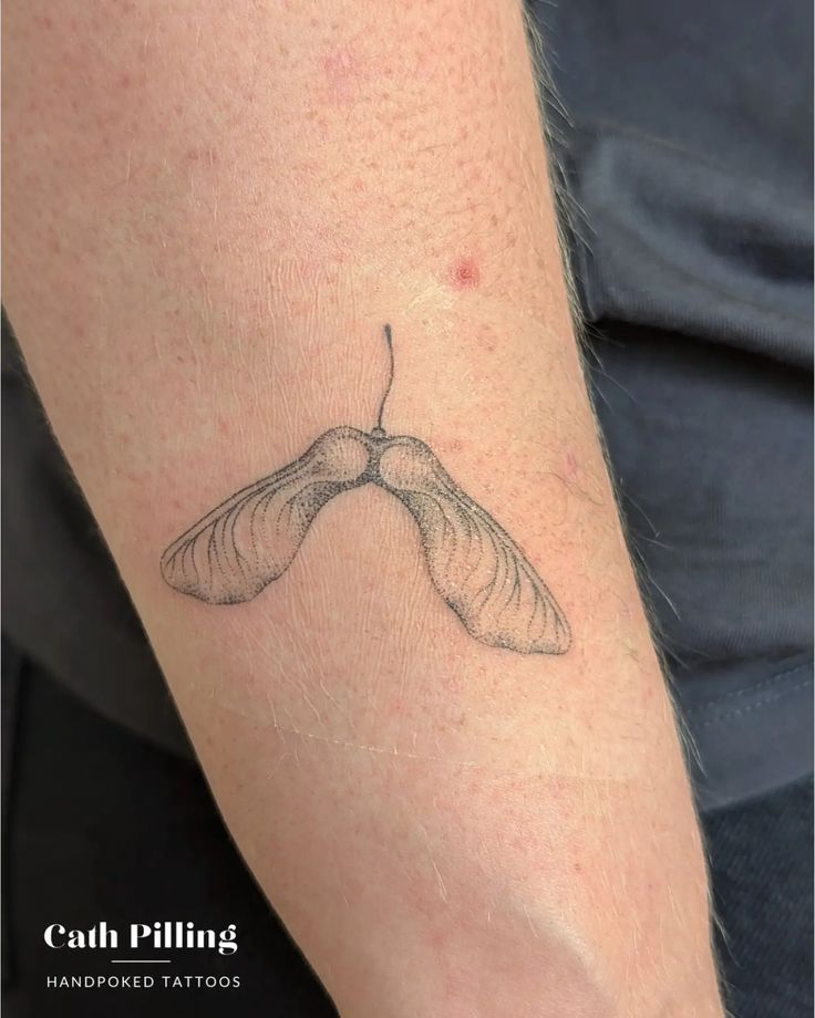 a close up of a person's arm with a small tattoo on the wrist