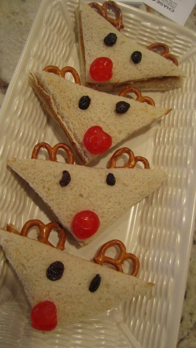 slices of pizza with pretzels and cherries are arranged on a plastic plate