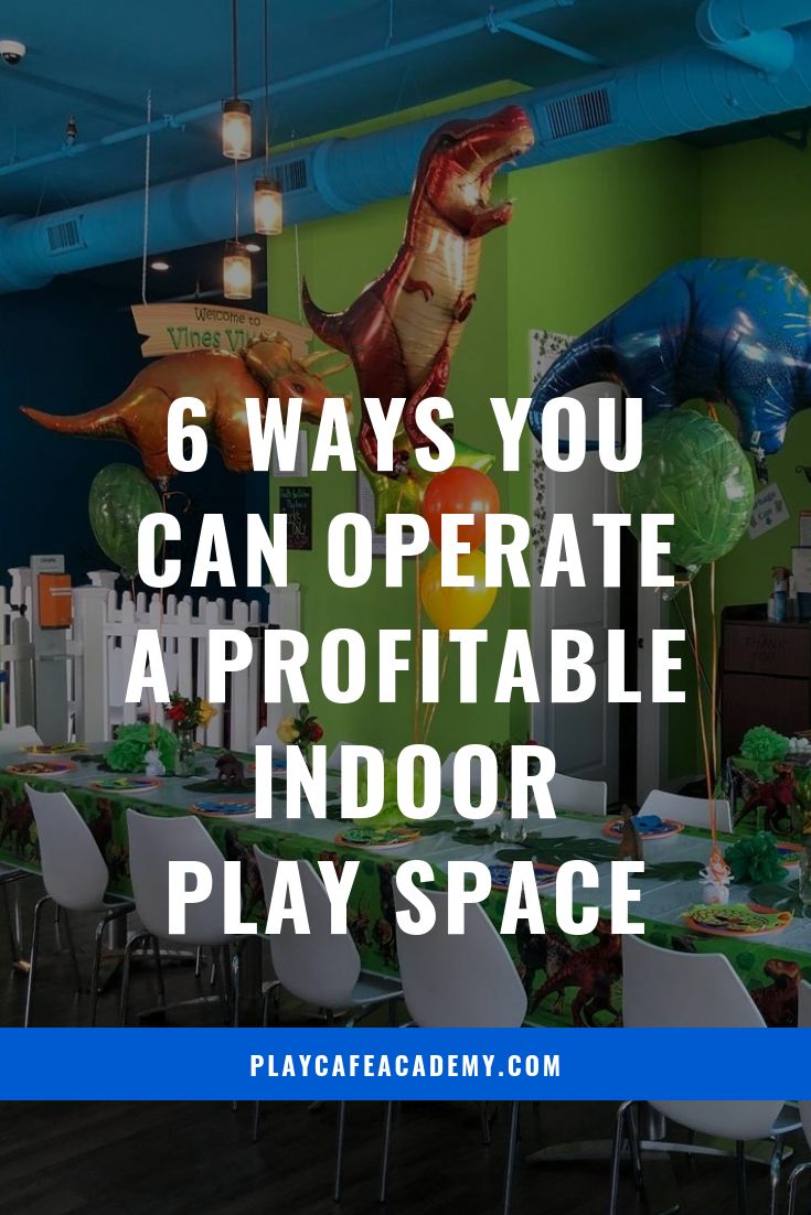 an indoor play space with dinosaur decorations and balloons